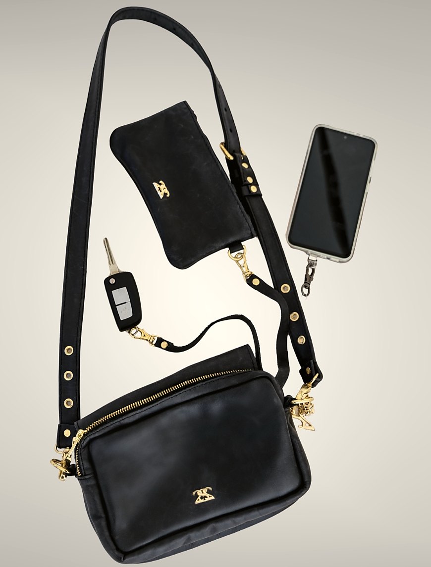 The bag with strap, backflap, retractable tether and key strap
